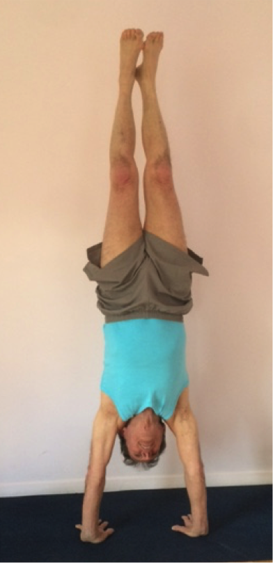 Person doing a handstand indoors