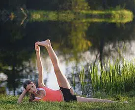 Yoga pose by a tranquil lakeside.