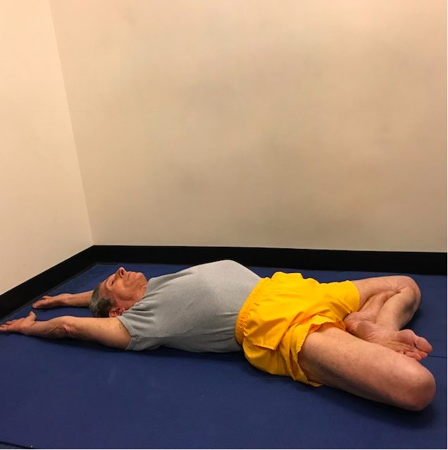 Individual practicing yoga in a small room