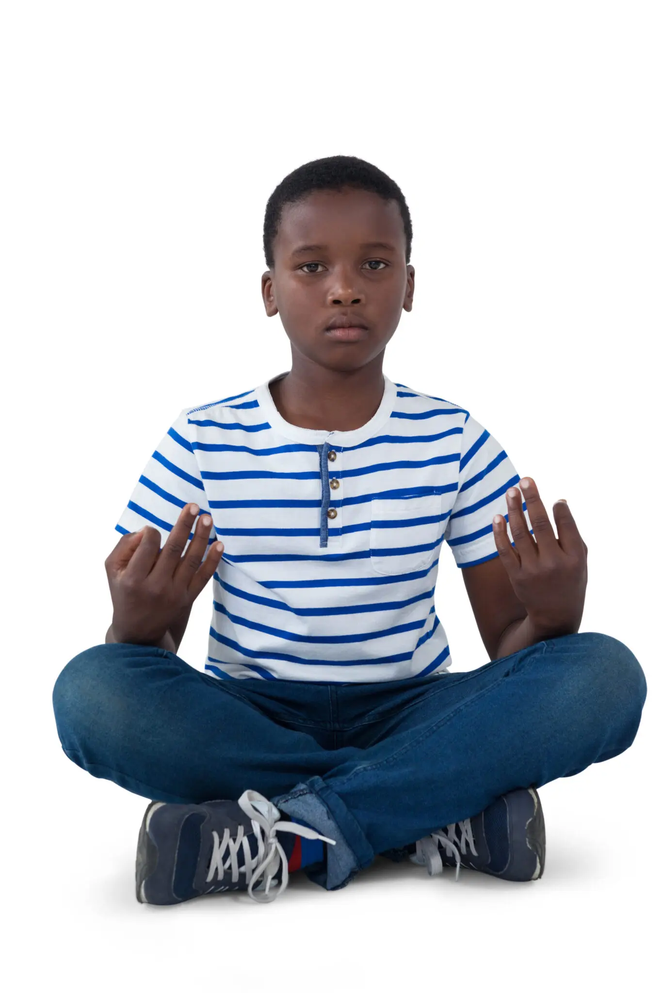 Boy meditating in striped shirt