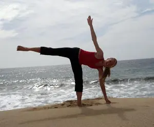 Balancing yoga pose near waves
