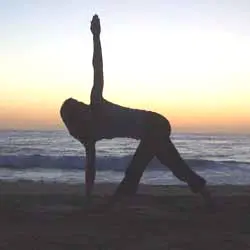 Yoga pose at sunset beach
