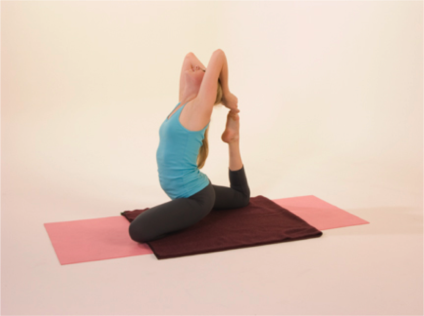 Woman practicing yoga pose on mats