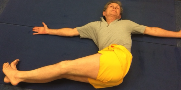 Individual wearing yellow shorts stretching