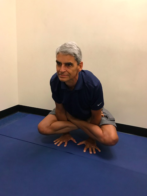 Individual performing a seated yoga position.
