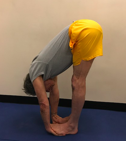 Man doing forward bend yoga pose