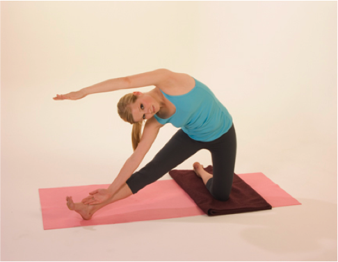 Woman practicing yoga on pink mat