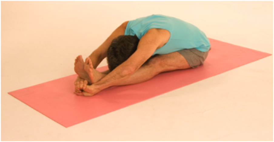 Man doing seated forward bend yoga pose