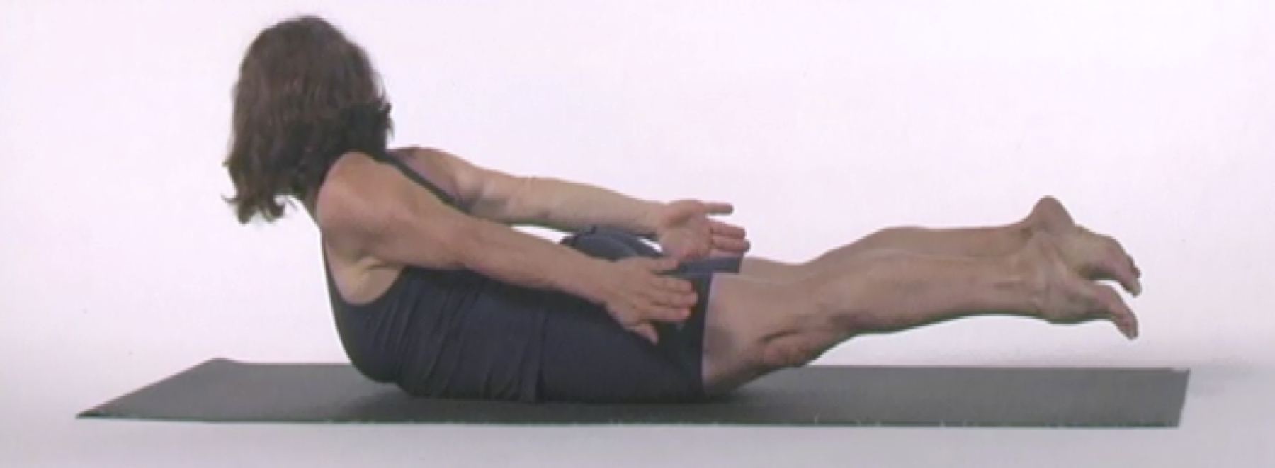 Woman performing yoga pose on mat