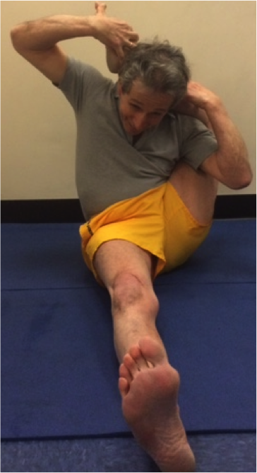 Individual stretching on a blue mat
