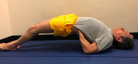 Man doing yoga bridge pose