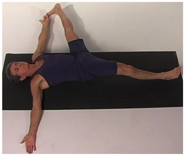 Individual practicing yoga exercise on floor