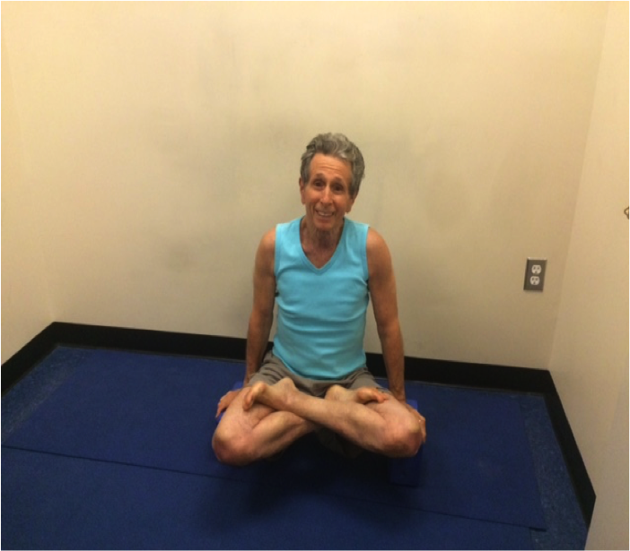 Person meditating in turquoise tank top