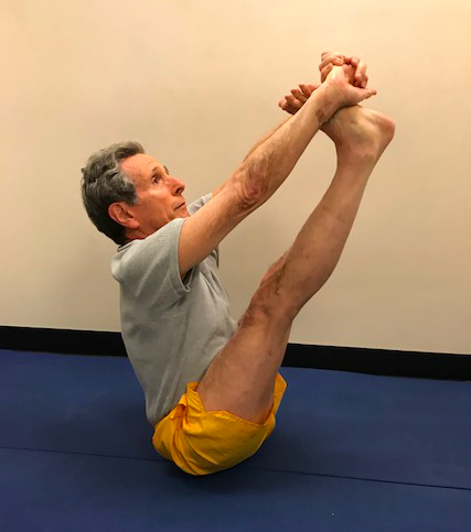 Man practicing seated yoga pose