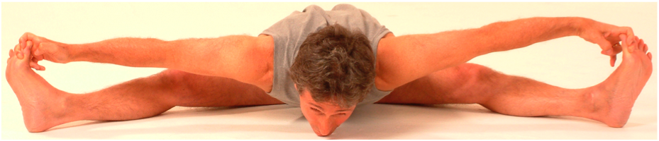 Person practicing flexibility exercise on floor