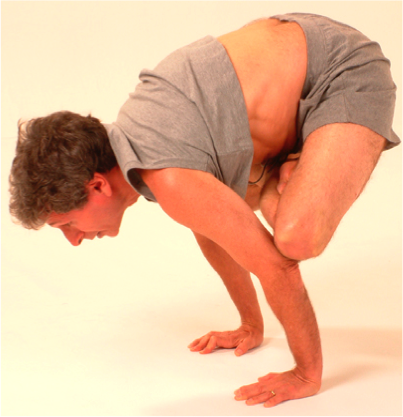 Man practicing advanced yoga pose