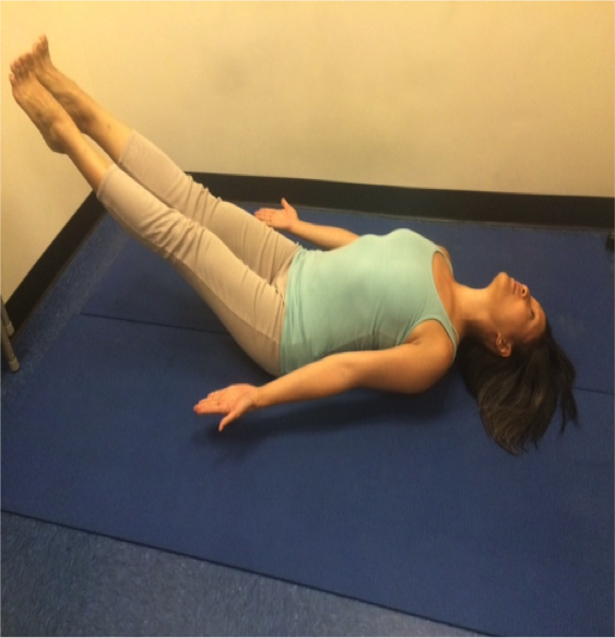 Woman doing a yoga pose on mat.