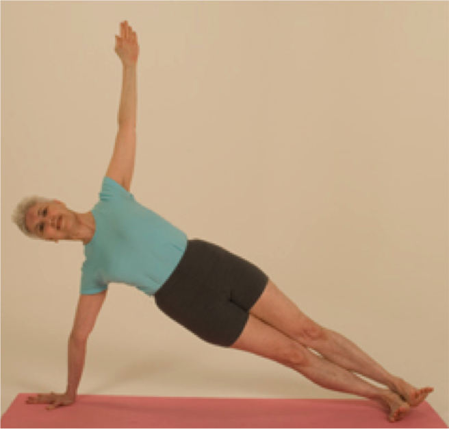 Person practicing side plank yoga pose