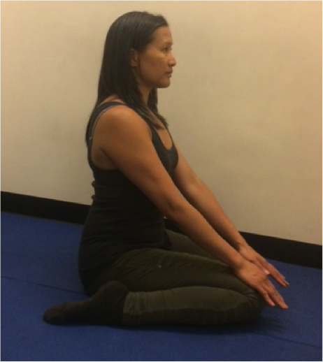 Woman practicing seated yoga pose