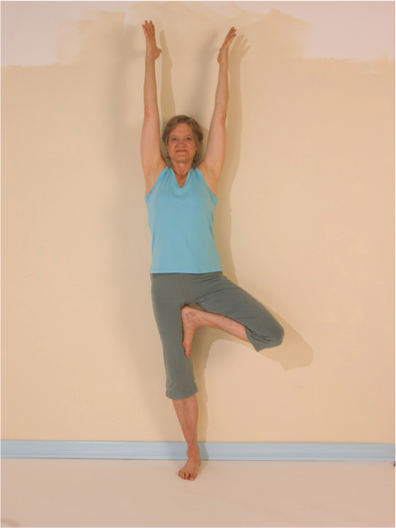 Yoga pose with raised arms and leg