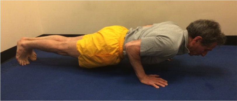 Person in yellow shorts doing push-up