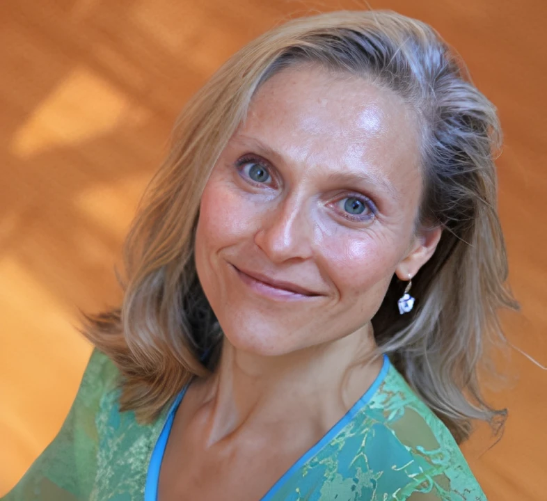Woman wearing green top, smiling