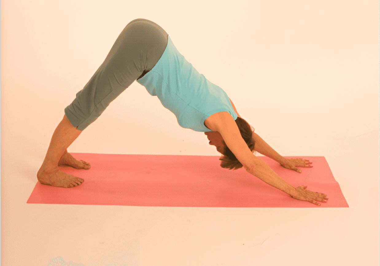 Person in yoga pose on pink mat