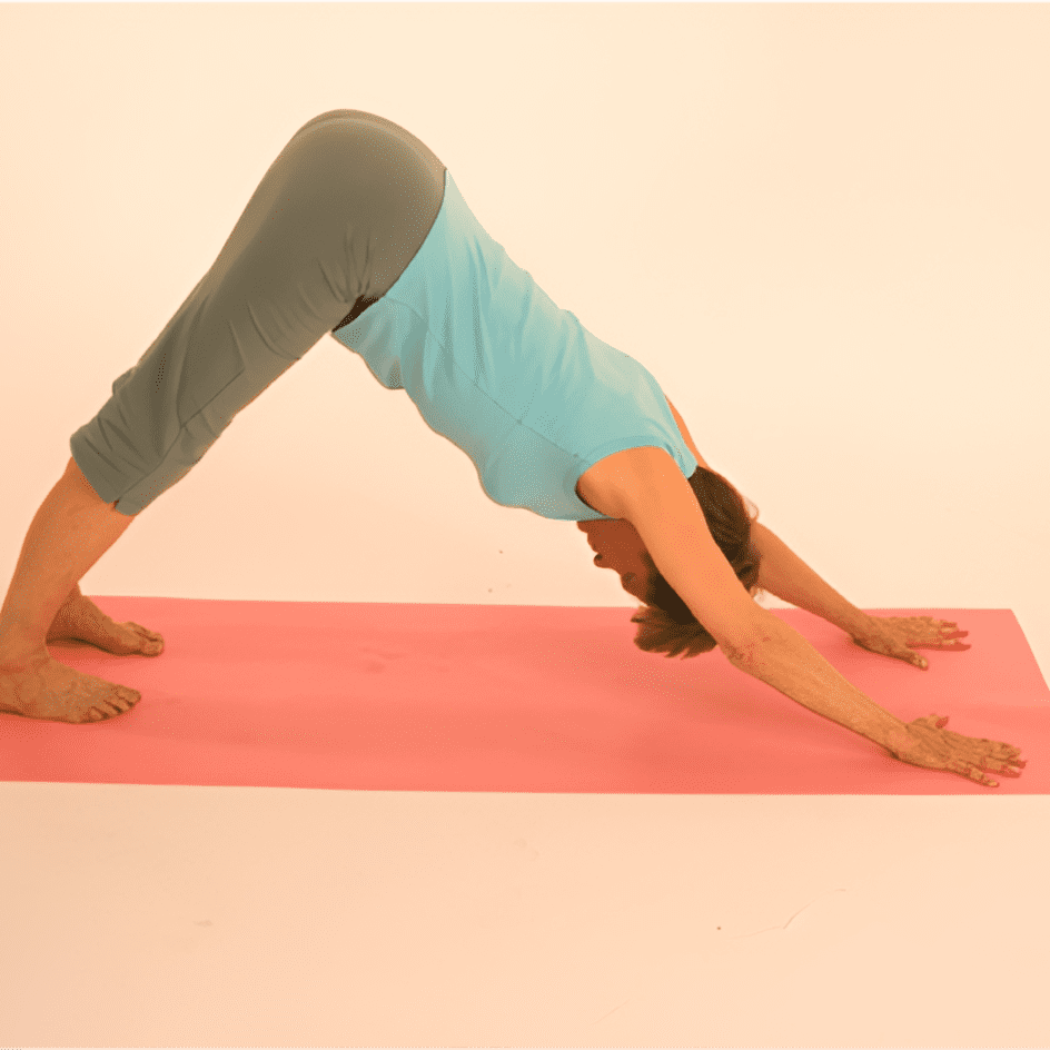 Person in yoga pose on pink mat