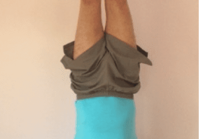 Person doing a handstand indoors