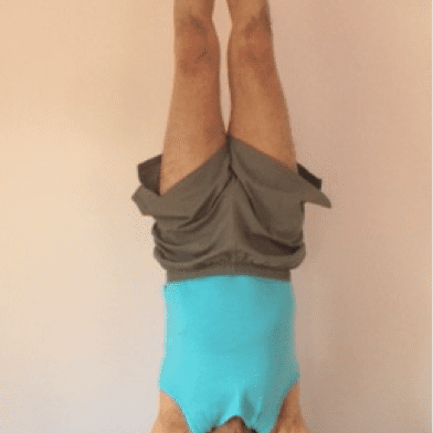 Person doing a handstand indoors