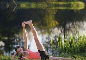 Yoga pose by a tranquil lakeside.