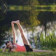 Yoga pose by a tranquil lakeside.