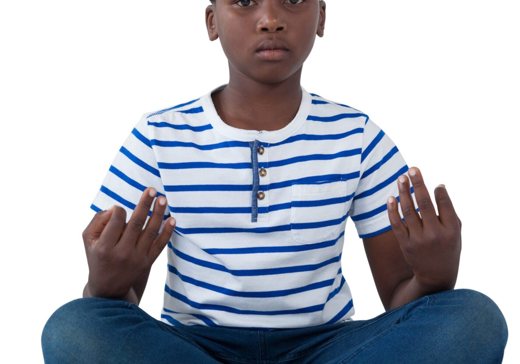 Boy meditating in striped shirt