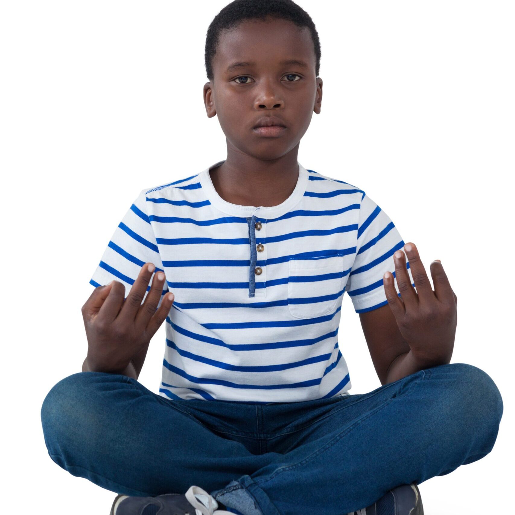 Boy meditating in striped shirt