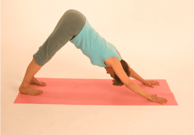 Person practicing downward dog yoga pose