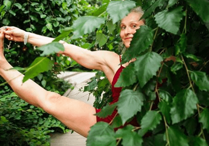 Flexible woman practicing yoga outdoors