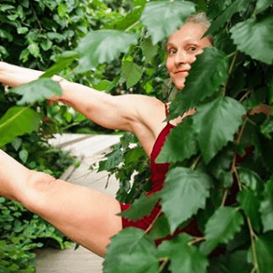 Flexible woman practicing yoga outdoors