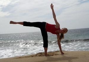 Balancing yoga pose near waves