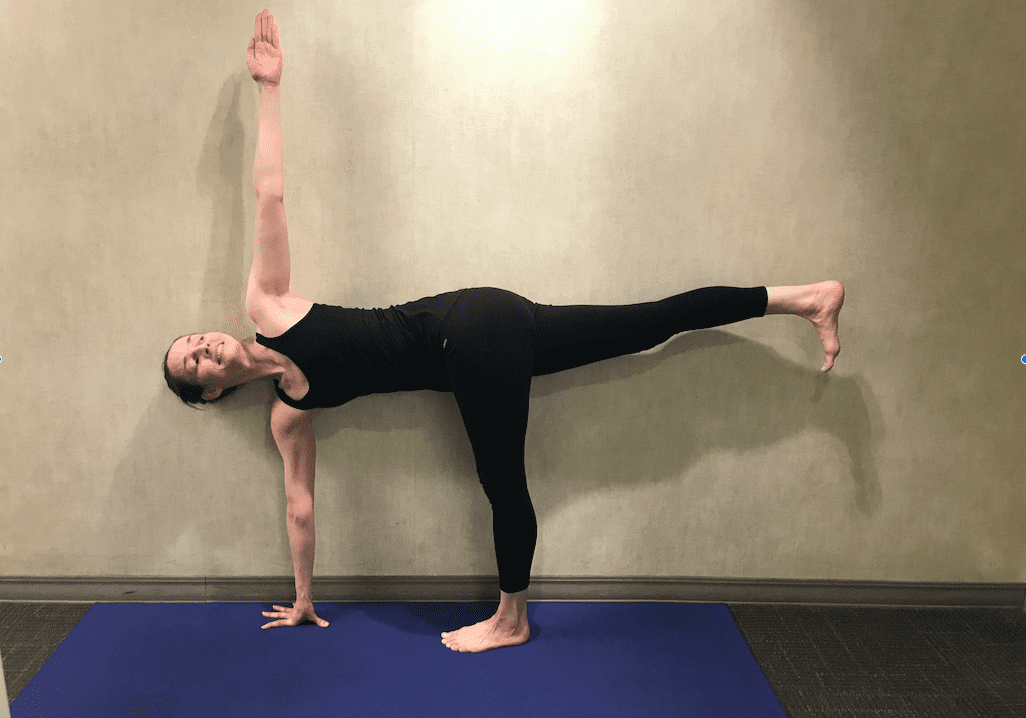 Person doing yoga on blue mat