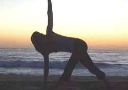 Yoga pose at sunset beach