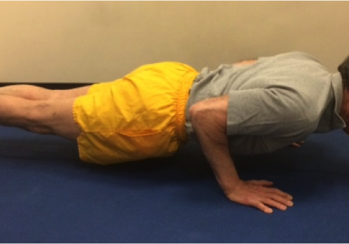 Person in yellow shorts doing push-up