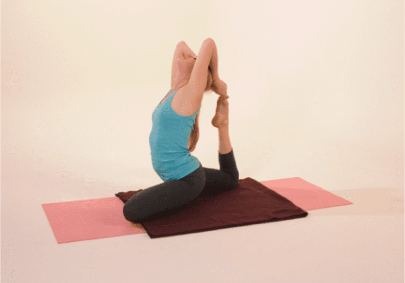 Woman practicing yoga pose on mats