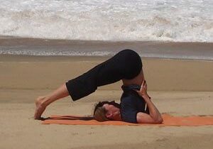 Person doing yoga on a beach