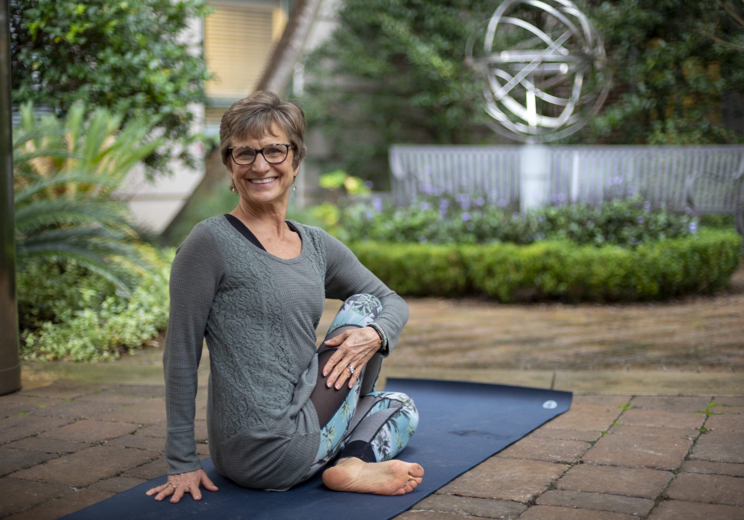 Smiling woman on yoga mat