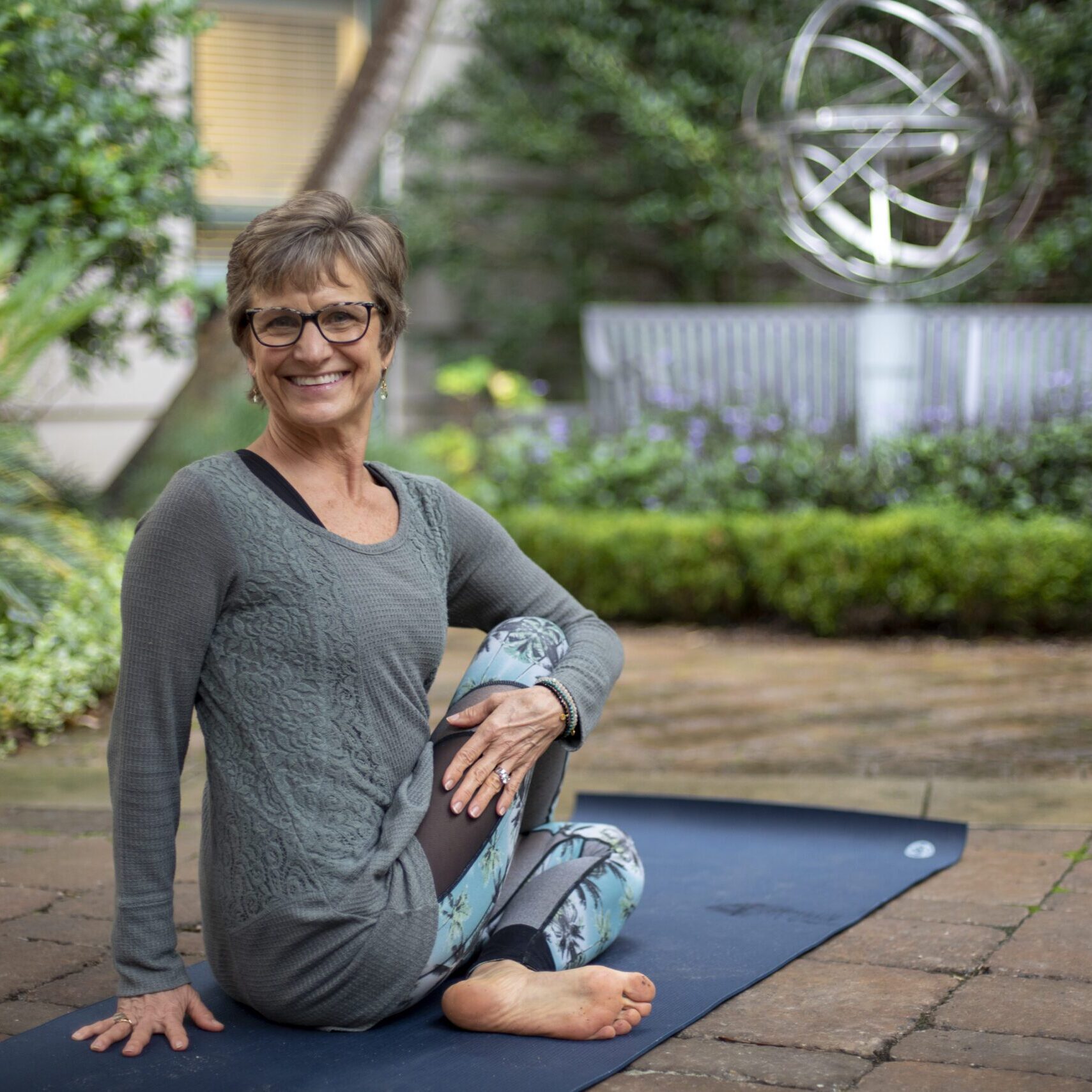 Smiling woman on yoga mat