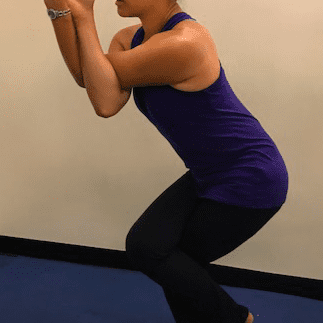 Person doing Eagle Pose on blue mat