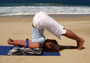 Beach yoga with ocean backdrop
