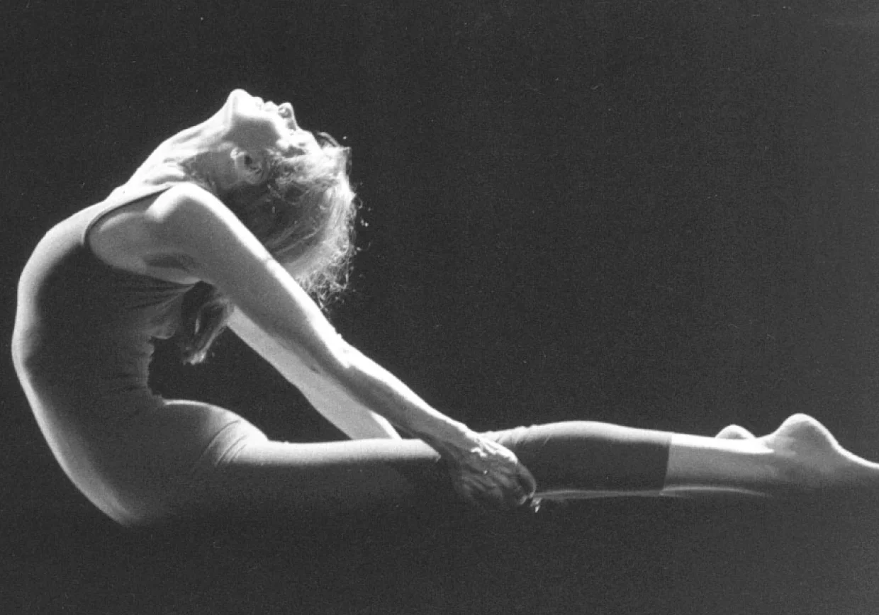 Artistic yoga pose in silhouette lighting.