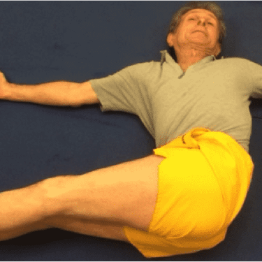 Individual wearing yellow shorts stretching