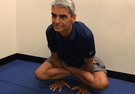 Individual performing a seated yoga position.